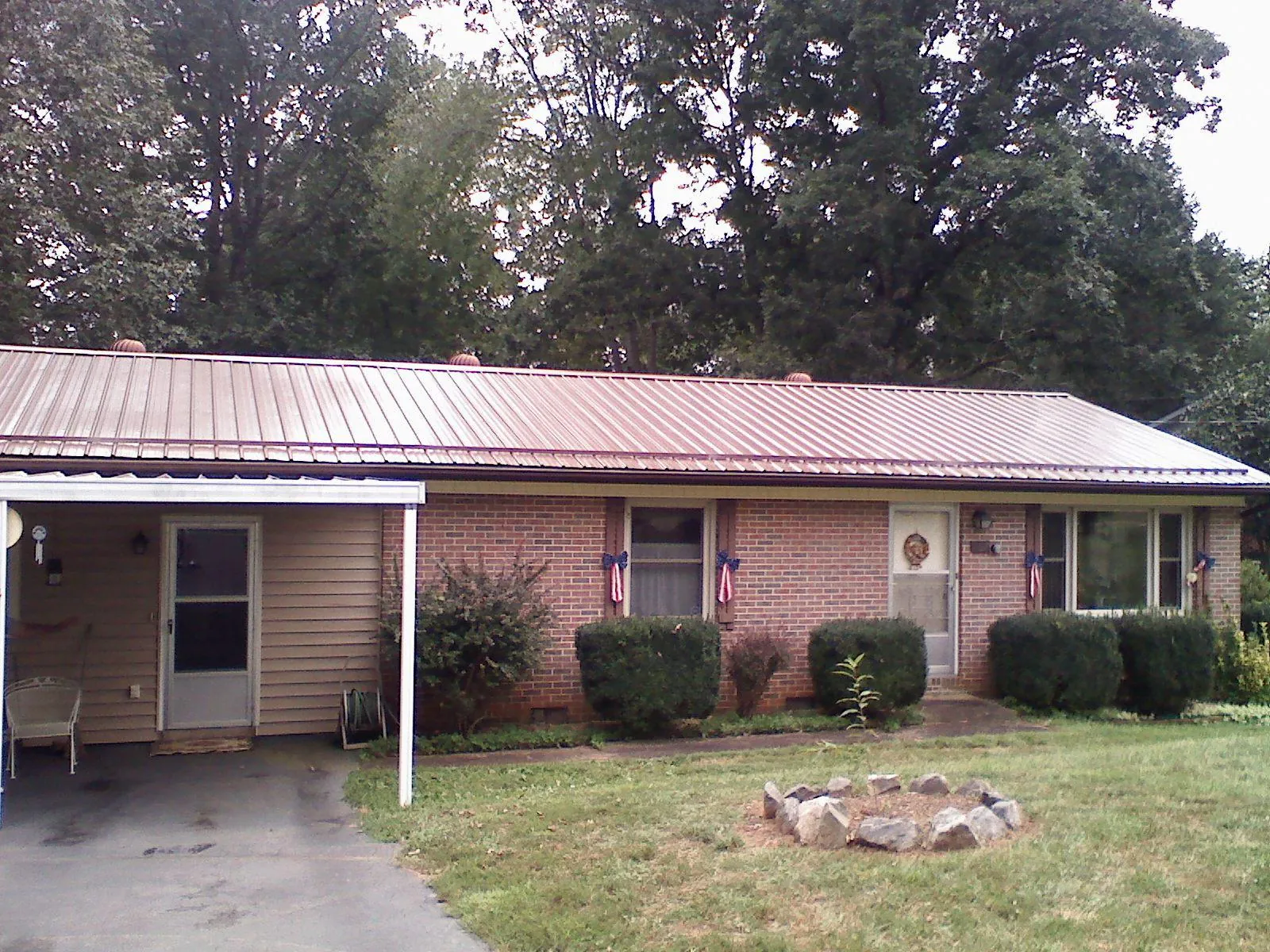 Bronze metal roof and carport on a brick ranch home — Roof Repair work by our crew in Seal Beach
